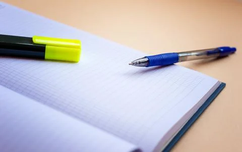 Highlighter and pen lying on a notepad and ready to work Stock Photos