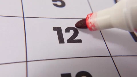 Highlighting date number 12 on a calendar, with a bold red cross mark Stock Footage 318468434