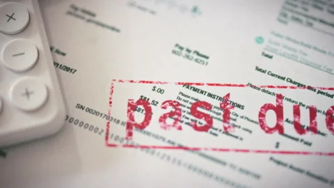 Highlighting financial burden close-up captures a red past due stamp on a ut Stock Footage 336570737