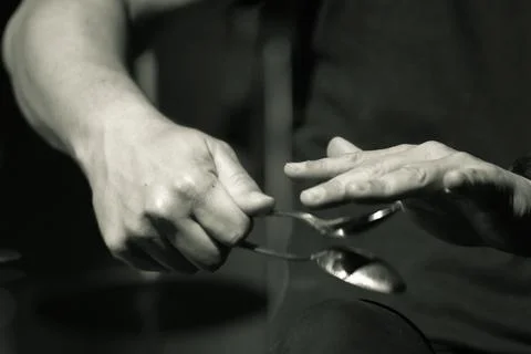 Highlighting the hands of a percussionist performing with two spoons. Stock Photos