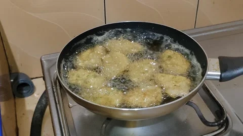 Highlighting “Hekeng” which is fried on the stove with hot oil in a wok Stock Footage 302373929