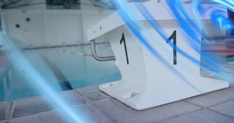 Highlighting white starting block labeled 1 on tiled deck shining under lights, Stock Photos