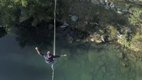 Highline walker over a mountain green lake Stock Footage 125475592