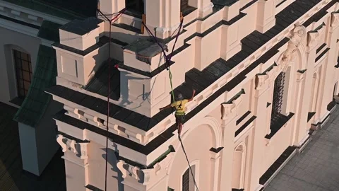 Highliner walking on slackline between old building in the old town of Lubl.. Stock Footage 318984308