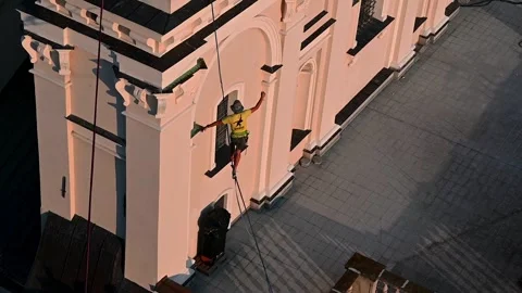 Highliner walking on slackline between old building in the old town of Lubl.. Stock Footage 318984310