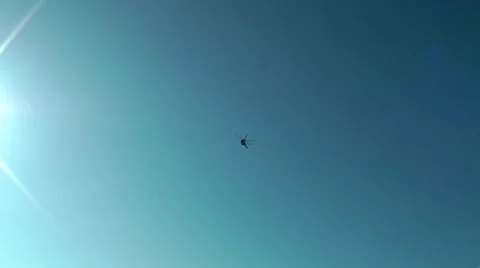 Highly in a blue clear sky the red passenger MI-8 helicopter flies Видео 20519536