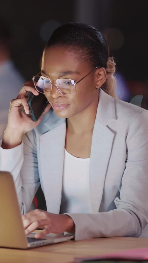 A highly dedicated professional is diligently working late at a computer in a Stock Footage 313797083