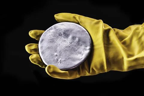 A highly enriched uranium billet. Highly radioactive material used in nuclear Stock Photos