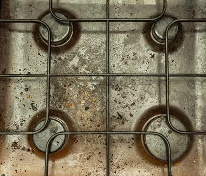 Highly polluted surface of the kitchen gas stove, top view Stock Photos