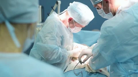 A highly qualified team of surgeons performs a complex operation to remove .. Stock Footage 253313337
