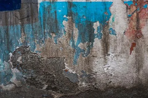 Highly weathered concrete wall with multiple layers of peeling blue paint Stock Photos