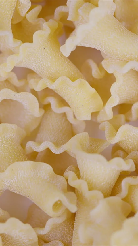 Highresolution image of ridged pasta shells. Macro view capturing coarse semolin Stock Footage 337355417