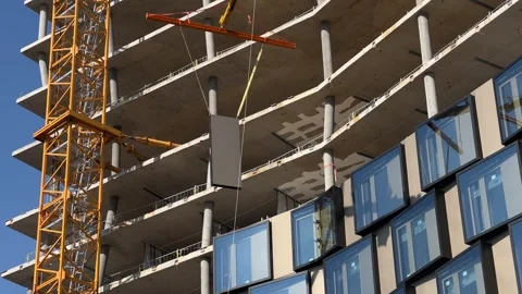 Highrise construction site with glass elements being fitted Stock Footage 284170409