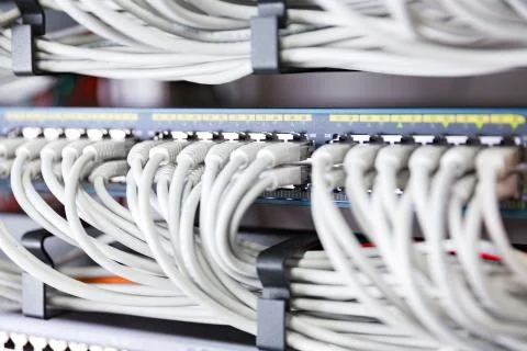 Highspeed network switch and perfect aligned patch cables in datacenter Stock Photos