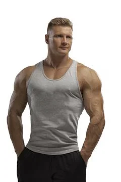 Hight-level bodybuilder posing in tank-top in white background Stock Photos