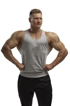 Hight-level bodybuilder posing in tank-top in white background Stock Photos