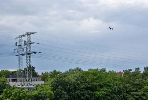 Hight voltage pole and blue sky and plane, electric cebles in Wroclaw, Poland Stock Photos
