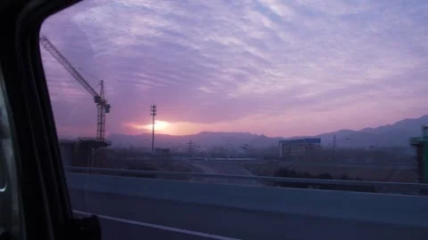 Highway and Construction Cranes at Sunrise Seen from Vehicle Near Hebei Stock Footage 345683397