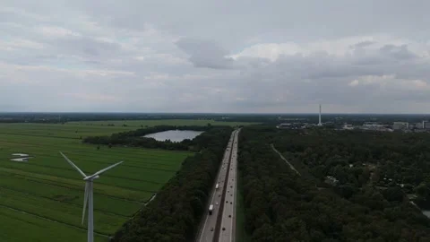 Highway And Wind Turbine Through Green Fields Aerial 動画素材 343026513