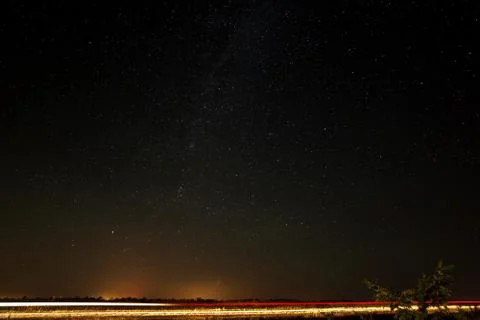 The highway on a background of the starry sky.  View of the Milky Way. Stock Photos