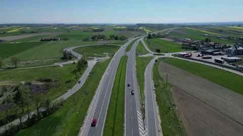 Highway between agricultural fields with roundabouts in Poland Video stock 335461613