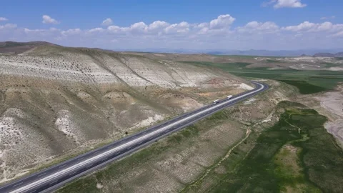 Highway Between Green Plains and Mountains Видео 337543735