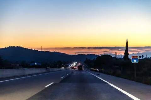 Highway between mountains in the evening Stock Photos