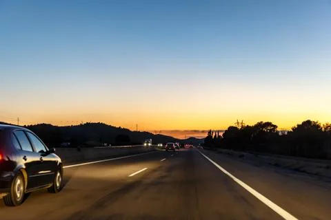 Highway between mountains in the evening Stock Photos