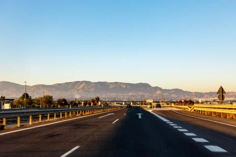 Highway between mountains in the evening Stock Photos