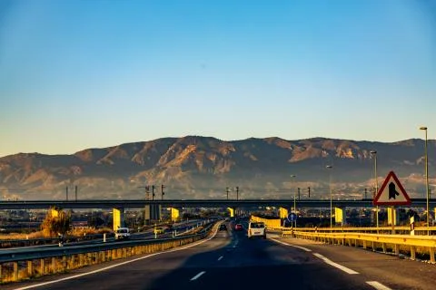 Highway between mountains in the evening Stock Photos