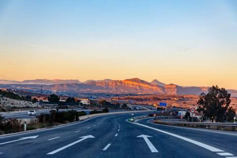 Highway between mountains in the evening Stock Photos