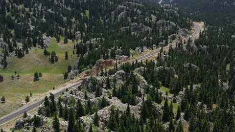 The highway between the mountains, rocks and forest. Areal view of the mountain Stock Footage 221044704