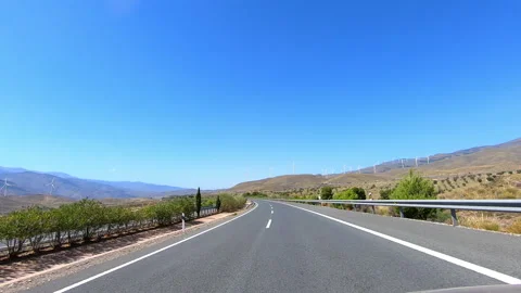 Highway between wind power turbines in Almeria Stock Footage 143628361