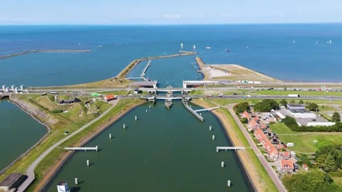 Highway bridge crosses complex lock systems small village numerous white sails 動画素材 327942180