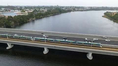 Highway bridge river train transportation flyover aerial footage Stock Footage 99816596