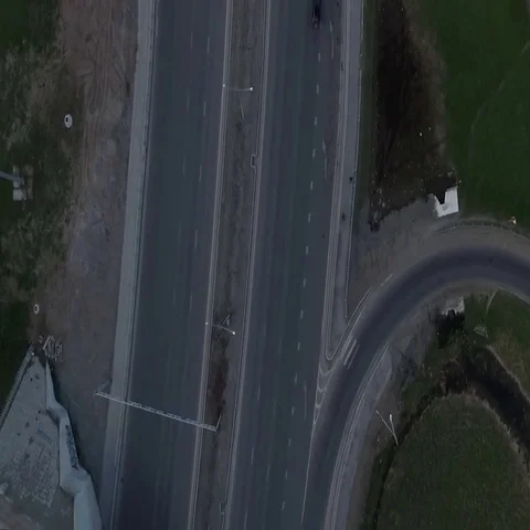 Highway with a circular intersection at which the traffic flow is going Stock-Footage 69575165