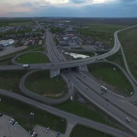 Highway with a circular intersection at which the traffic flow is going Stock Footage 69575391