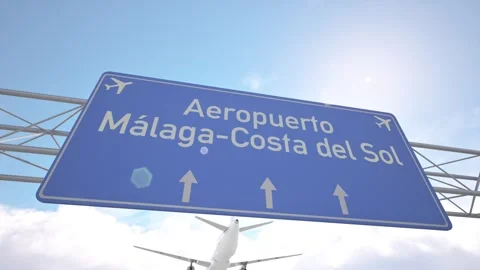 Highway direction sign for Malaga Costa del Sol Airport with plane arriving in Stock Footage 320026984