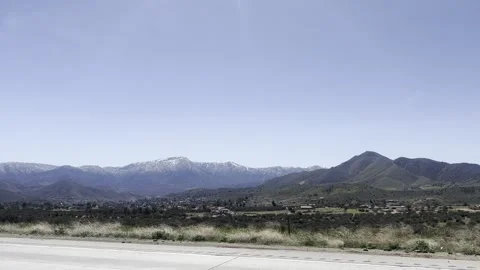 Highway drive through snowcapped mountains Stock Footage 243754400
