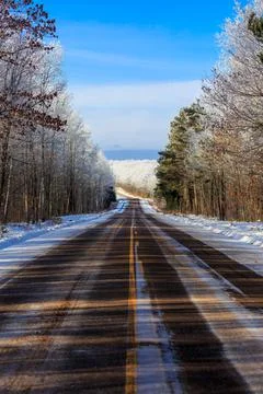 Highway E running through a frost covered forest in northern Wisconsin in Jan Stock Photos