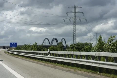 Highway with exit sign and distant bridge view of Stoerbruecke Stock Photos