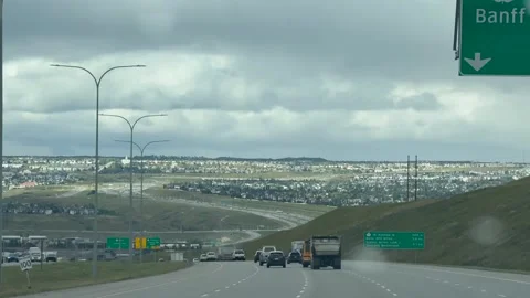 Highway exit signs for Banff and Calgary from moving vehicle Stock Footage 346879213