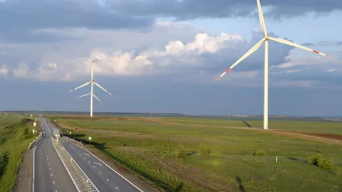 Highway, fields and wind power plant from above Stock Footage 131551746