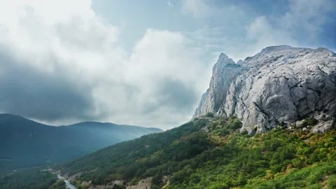 The highway at the foot of the mountain, the dramatic sky in the background Stock Footage 217406176