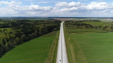 Highway with green fields and forests, aerial shot Stock Footage 86099237