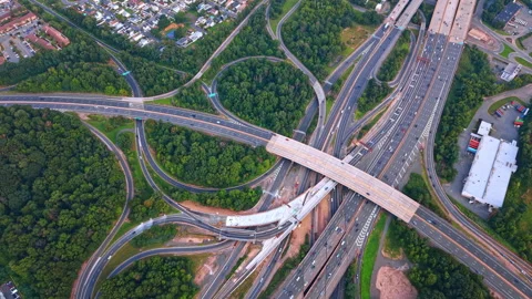 Highway interchange with looping ramps and intersecting bridges. Roads curve Stock Footage 346612755