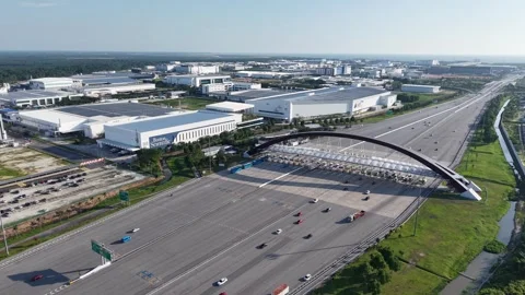 Highway interchange with modern overpass and industrial warehouses Stock Footage 341720528