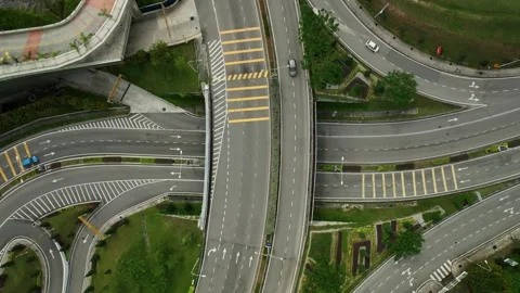 Highway interchange with multiple lanes and landscaping in a bustling city Stock Footage 311987082