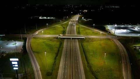 A highway interchange at night, viewed from an elevated perspective. Stock-Fotos