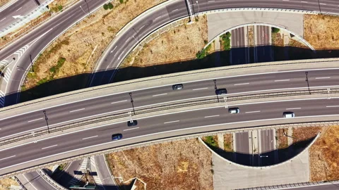 Highway interchange showing multiple levels of roads during daytime with Stock Footage 344249374